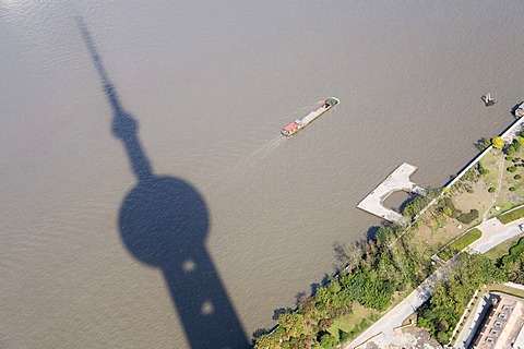 Shadow of the Oriental Pearl Tower falls on the Huangpu River, Pudong, Shanghai, China