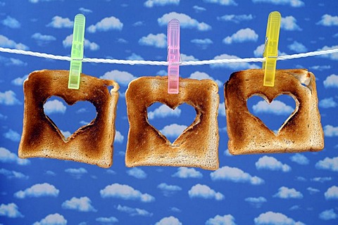 Toasts with cut out hearts on a clothesline