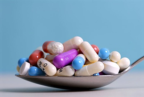 Tablets and pills on a spoon