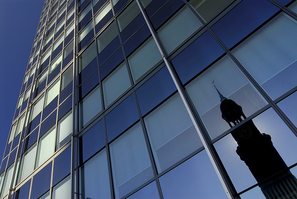 Reflection of St. Michaelis church in a glass front of an office building in Hamburg, Germany