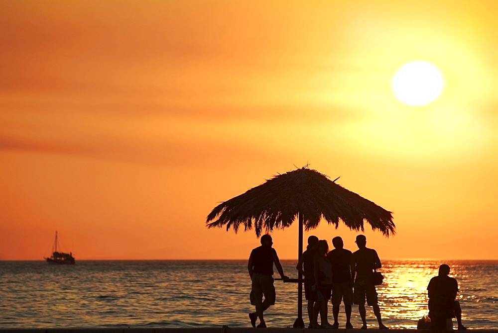 Tourists watching the sun go down over the Adriatic Ocean