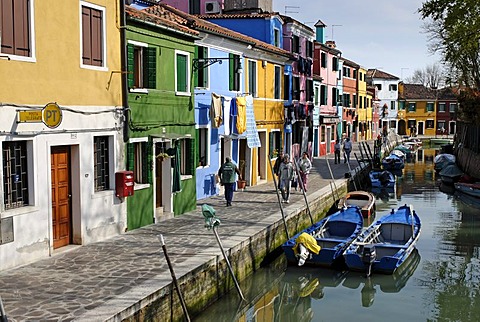 Colourfully painted houses along a canal on Burano, an island in the Venetian Lagoon, Italy, Europe