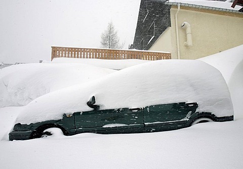 Snowed in car in Oberwiesenthal, Erzgebirge, Erz Ore Mountains, Saxony, Germany