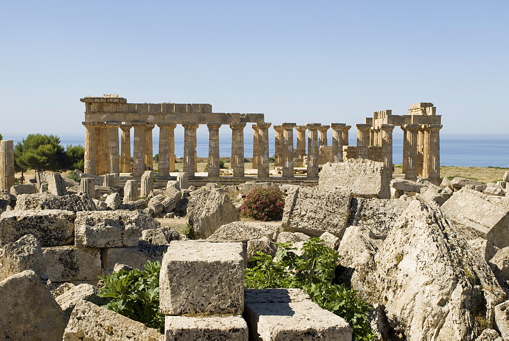 Remaining rubble of Temple G and Temple E (back) at the ancient Greek archaeological site in Selinunte, Sicily, Italy