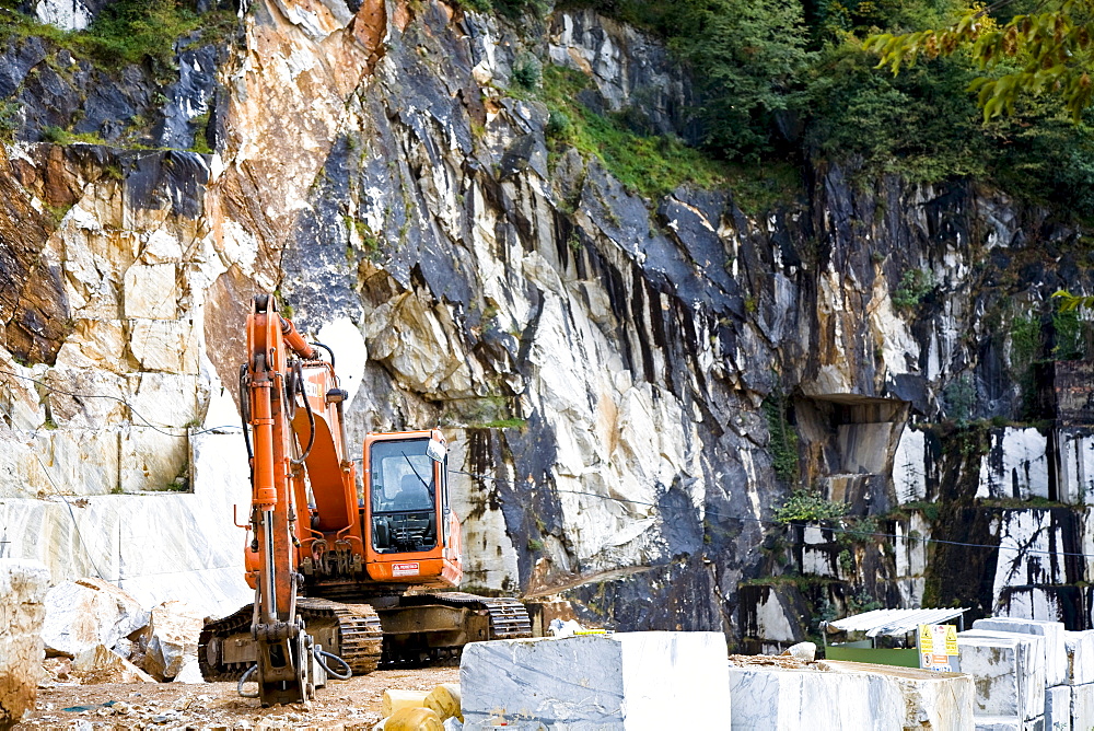 Mechanical shovel excavator in the marble stone pit of Carrara Tuscany Italy