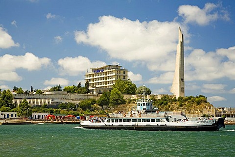 Sightseeing Ship near Harbour Quay with the big Memorial of 2. World War in the background, Sevastopol, Crimea, Ukraine, South-Easteurope, Europe,