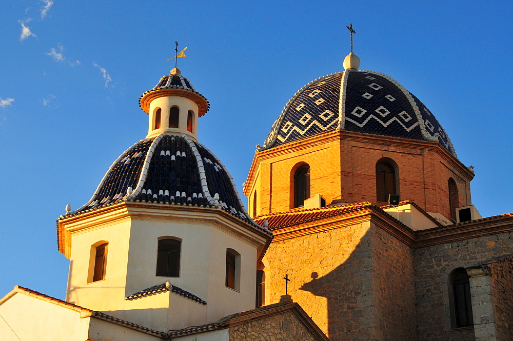 Tiled domes of the golden yellow Iglesia de Nuestra Senora del Consuelo Church, Altea, Costa Blanca, Spain