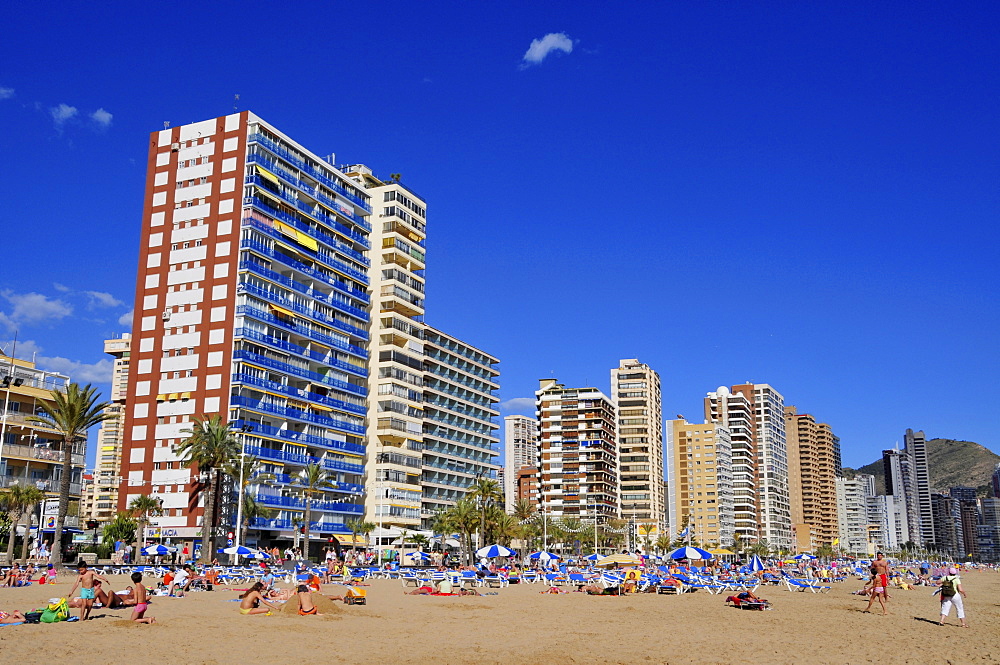 Tourists and high-rises on the beach at Benidorm, Costa Blanca, Spain