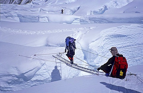 Crossing of a crevasse by ladder, Western Cwm, 6000m Mount Everest, Himalaya, Nepal