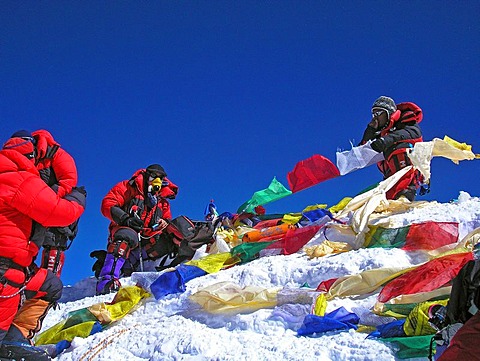 Mountain guide Vern Tejas and Lhakpa Rita Sherpa with tibetan praying flags on the summit of Mount Everest 8848m, Himalaya, Nepal