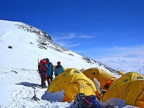 Yellow tents, alpinists and equipment in Camp IV, 4, on South Col, 7950m, Mount Everest, Himalaya, Nepal