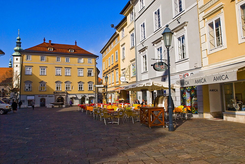 Outdoor cafe on the cobbled old town square surrounded by beautiful old buildings and ornate street lamps in Klagenfurt, Carinthia, Austria