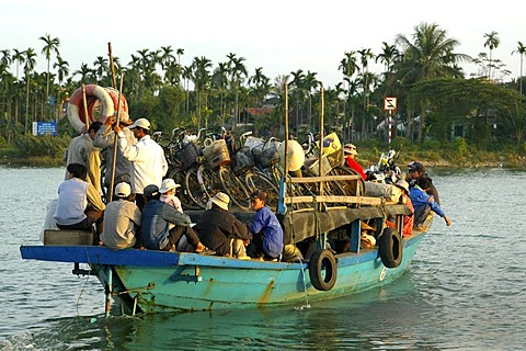 Overcrowded ferry boat crossing the Thu Bon River in Hoi An, Vietnam