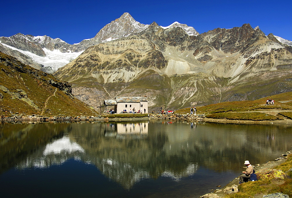 Chapel Maria at teh Snow at lake Schwarzsee, peaks Oberes Gabelhorn, Wellenkuppe, Zermatt Valais Switzerland