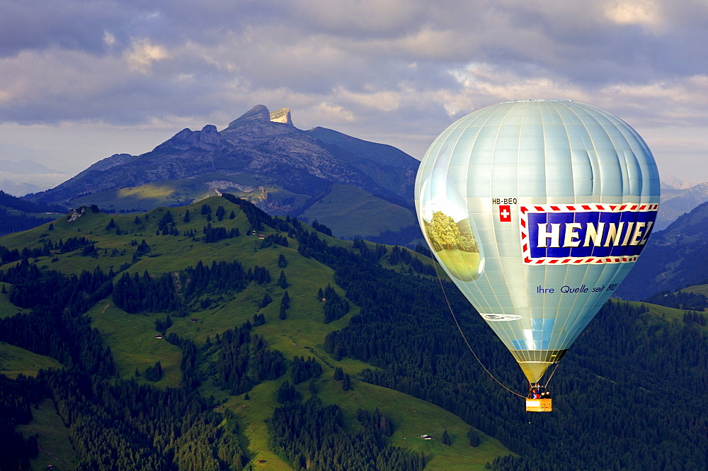 Hot air balloon in front of peaks Tour d'Ai, Tour de Mayen, Chateau-d'Oex, Switzerland