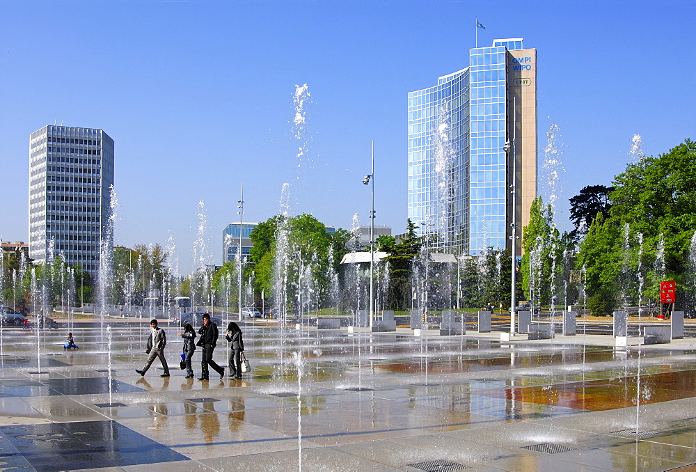 Trick fountains on the Square of Nations, Place des Nationen in Geneva, ITU Headquarters (left), WIPO, UPOV buildings on the right, Geneva, Switzerland