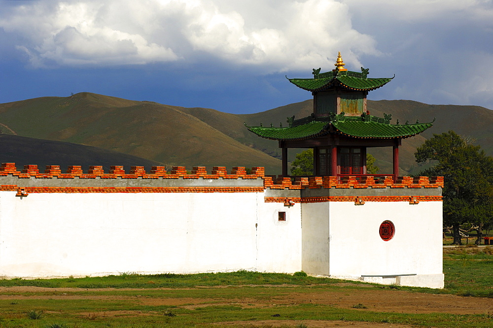 White wall and tower of the Mongolia Hotel built in the style of a Buddhist temple, steppes visible at back, Ulan Bator or Ulaanbaatar, Mongolia, Asia