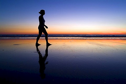 Silhouette of a woman at the beach at sunset, Cable Beach, Australia