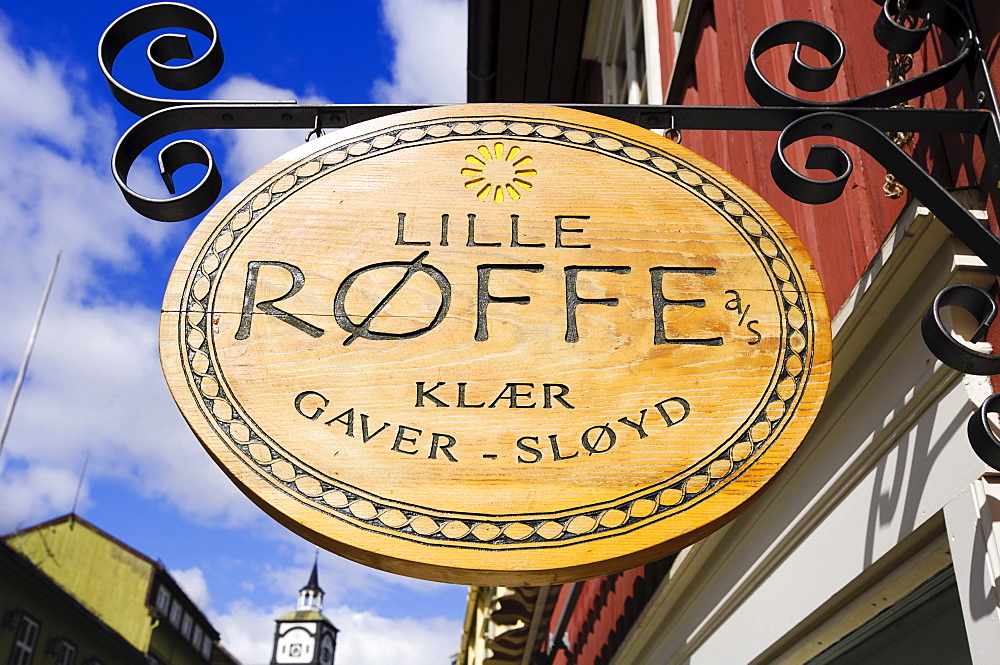 Wooden sign hanging outside a shop in Roeros, iron mining town, UNESCO World Heritage Site, Sor-Trondelag, Norway