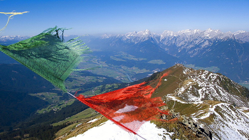 View over Inn Valley toward the Karwendel Range, prayer flags flapping in the wind, Kellerjoch Cabin, Schwaz, Tirol, Austria