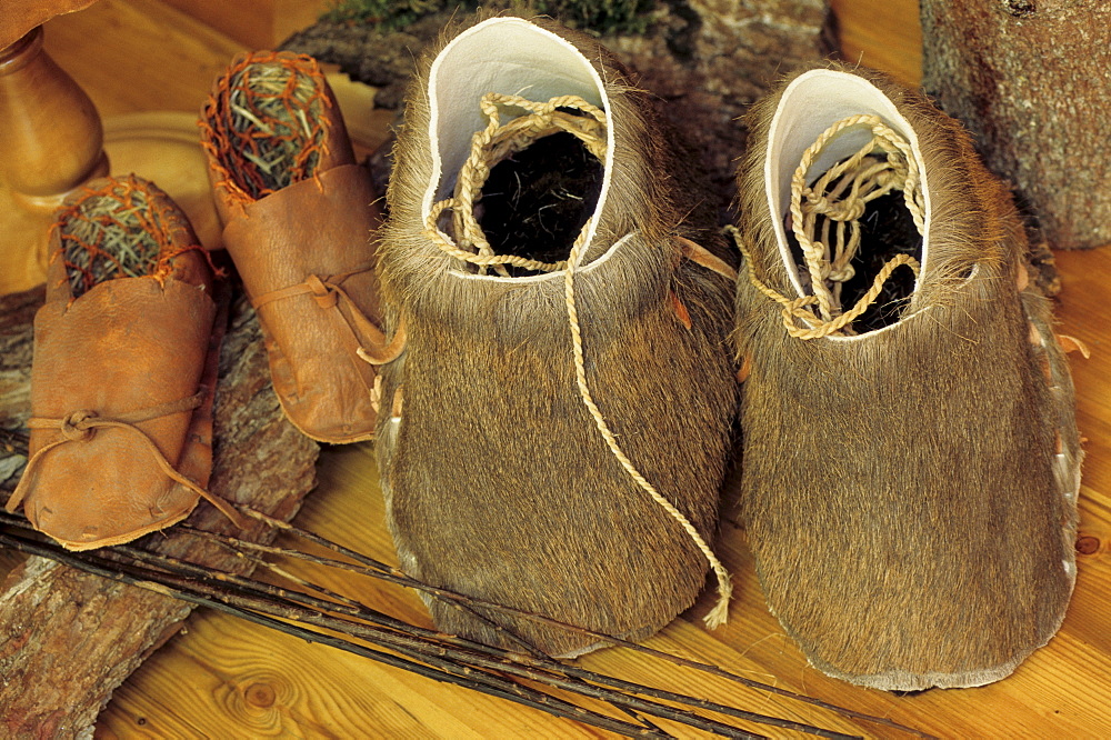 Leather shoes, moccasins made of fur and straw in the Oetzi or Iceman Museum in Oetzi Village, Tyrol, Austria, Europe