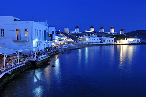 Tourists seated at restaurants in Little Venice, windmills, evening mood, Mykonos Island, Cyclades, Greece, Europe