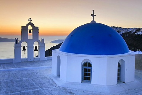 White Greek church with a blue dome and a bell tower at sunset, Firostefani, Santorini, Cyclades, Greece, Europe