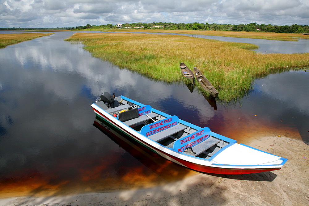 Wooden canoes at the shore of Lake Capoey, Guyana, South America