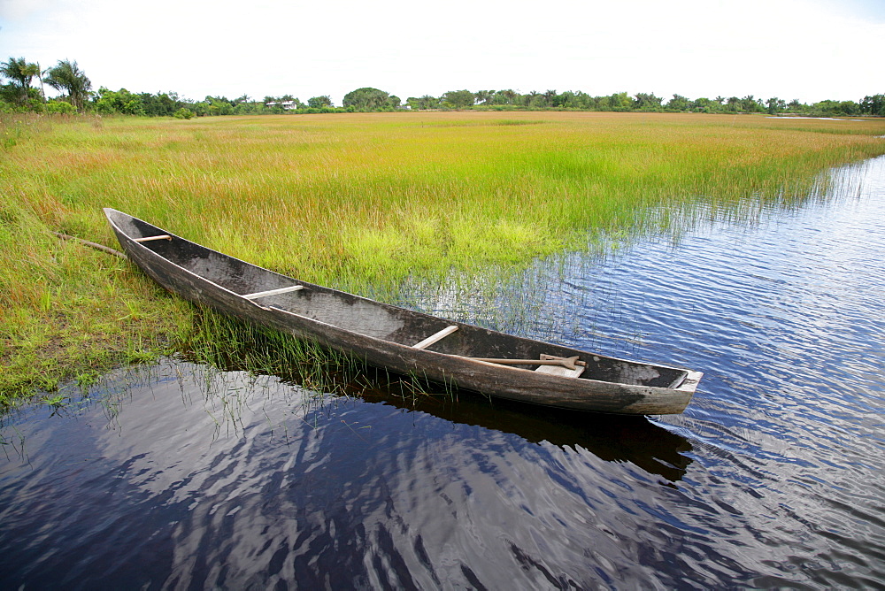 Wooden canoe at the shore of Lake Capoey, Guyana, South America