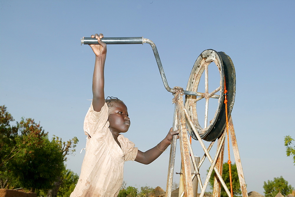 Boy fetching water from a well, Cameroon, Africa