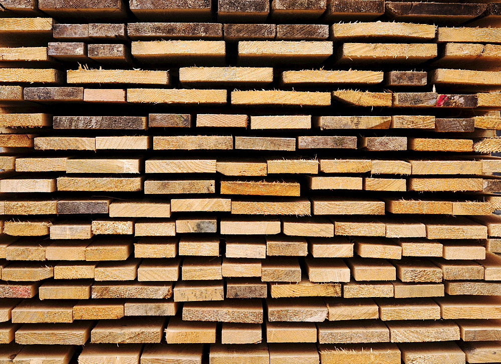 Stacked wooden boards, building material, view of the ends, image-filling