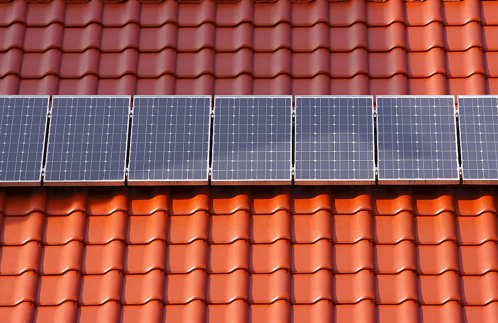 Solar panels on a red tiled roof