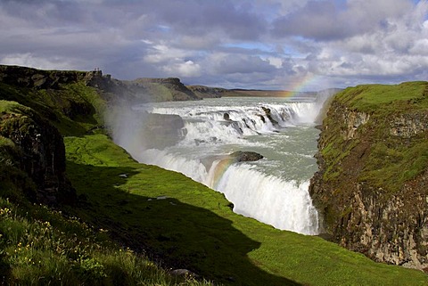 Gullfoss-Waterfall at the Hvita-River near by the Langjoekull-Glacier in Iceland with rainbow in the evening light Golden Waterfall Iceland