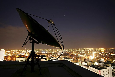 Satellite dishes on the roof of a high rise building