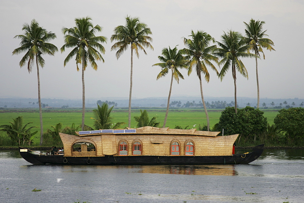 Typical rice boats on the Backwaters, a canal system along the coastline, boat is also accommodation for tourists, Kerala, India