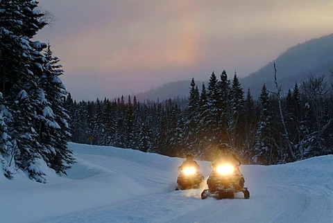 CAN Canada Quebec : Snowmobile driving during winter region Saguenay - Lac Saint Jean Monts Valin.