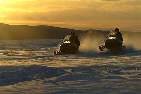 CAN Canada Quebec : Snowmobile driving during winter region Saguenay - Lac Saint Jean Monts Valin.