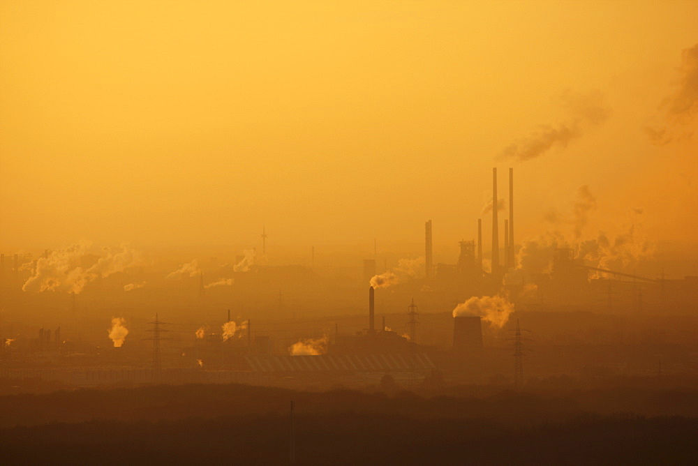 Hazy view of the Thyssen-Krupp steelworks at Hamborn, Schwelgern at sunset, near Duisburg, North Rhine-Westphalia, Germany, Europe