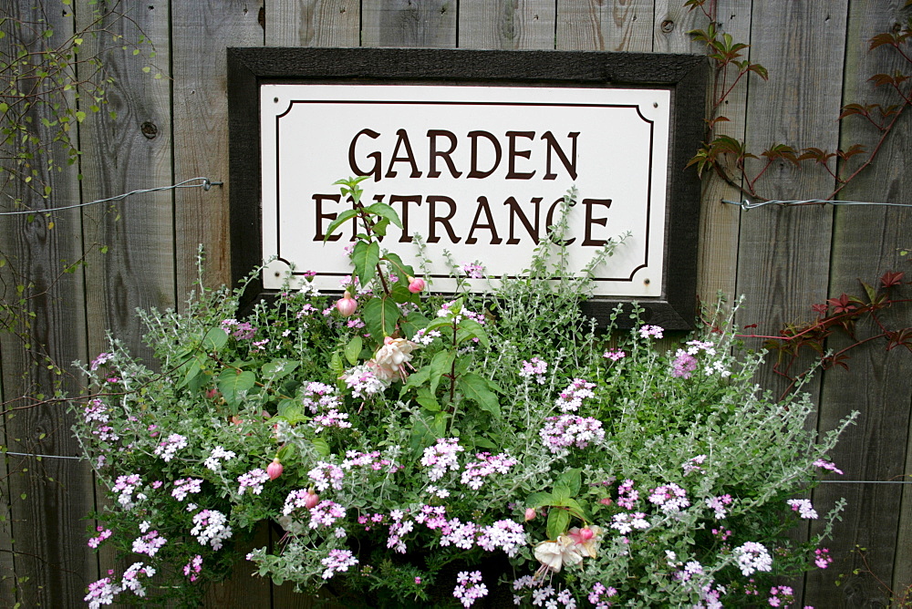 Sign on wooden wall "Garden Entrance", The Lost Gardens of Heligan, Pentewan, St. Austell, Cornwall, Great Britain