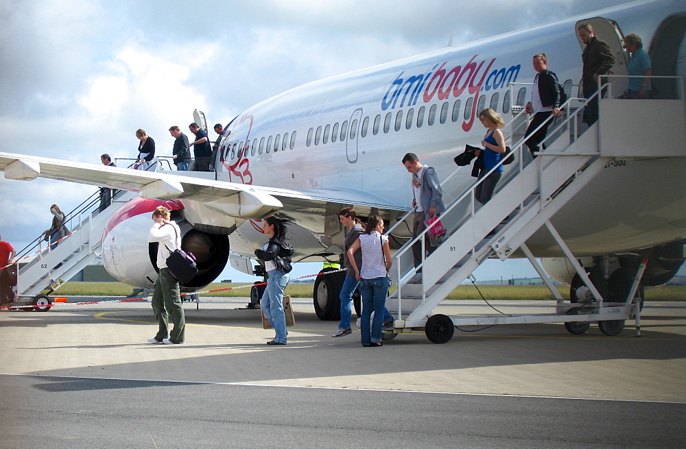 Passengers leaving a Boeing 737 of bmibaby at Newquay Airport, Cornwall, Great Britain