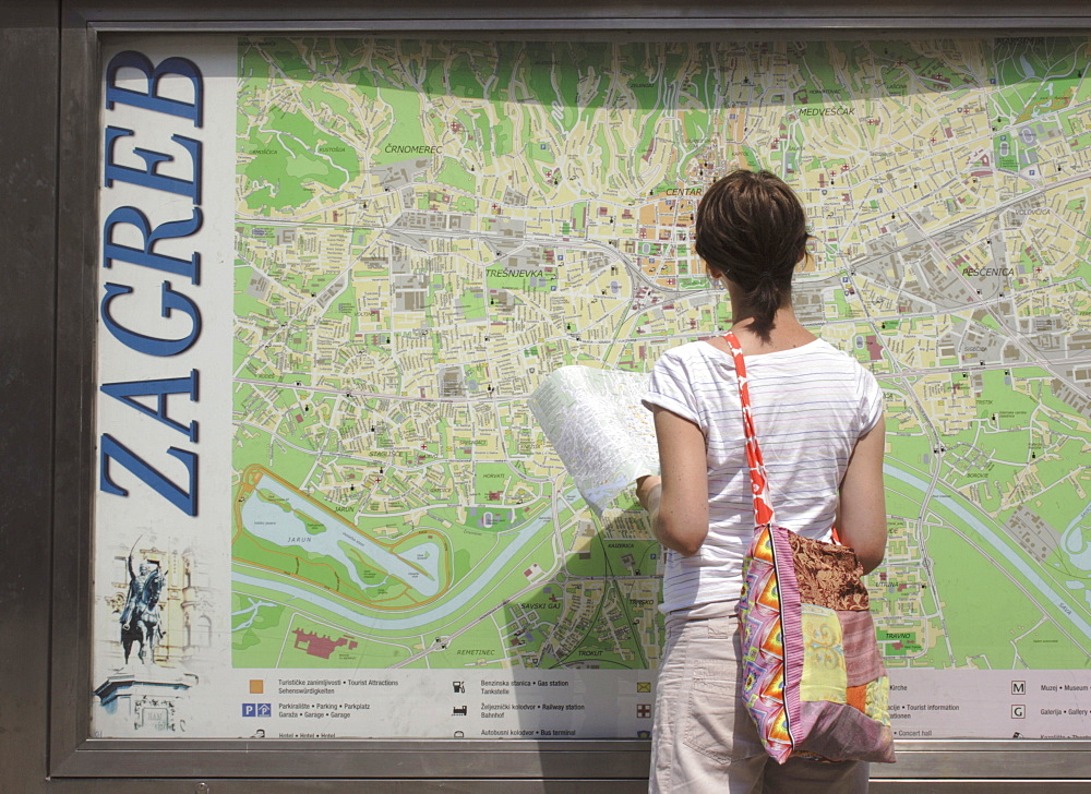 Female tourists looking at city map, Zagreb, Croatia