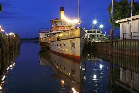 Night-time illuminated pleasure paddle steamer "Ludwig Fessler" in Prien harbour, Lake Chiemsee, Chiemgau, Upper Bavaria, Germany, Europe