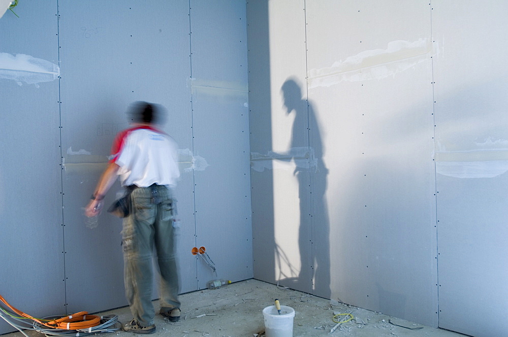 Construction worker inside an house shell