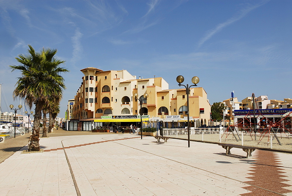 Boulevard and buildings of the Port Leucate harbour, Departement Aude, France