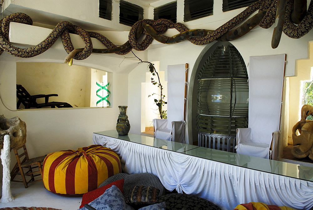 Throne chairs and an old lighthouse lamp dominate dining area at the head of the swimming pool at the former home of surrealist painter Salvador Dali and his wife Gala in Port Lligat, Province Girona, Spain