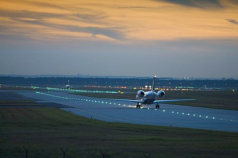 An aeroplane rolls in the evening light to the runway, airport of Frankfurt, Hessen, Germany.