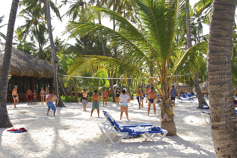 Tourists playing beach volleyball at an all-inclusive resort as part of the its organized activities program in the Dominican Republic, Caribbean, Americas