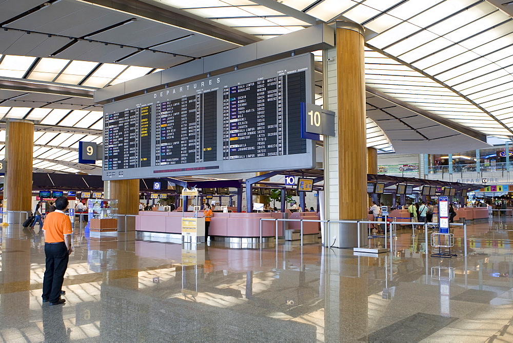 Departure hall, departure board and check-in counters at Changi Airport, Singapore, Southeast Asia