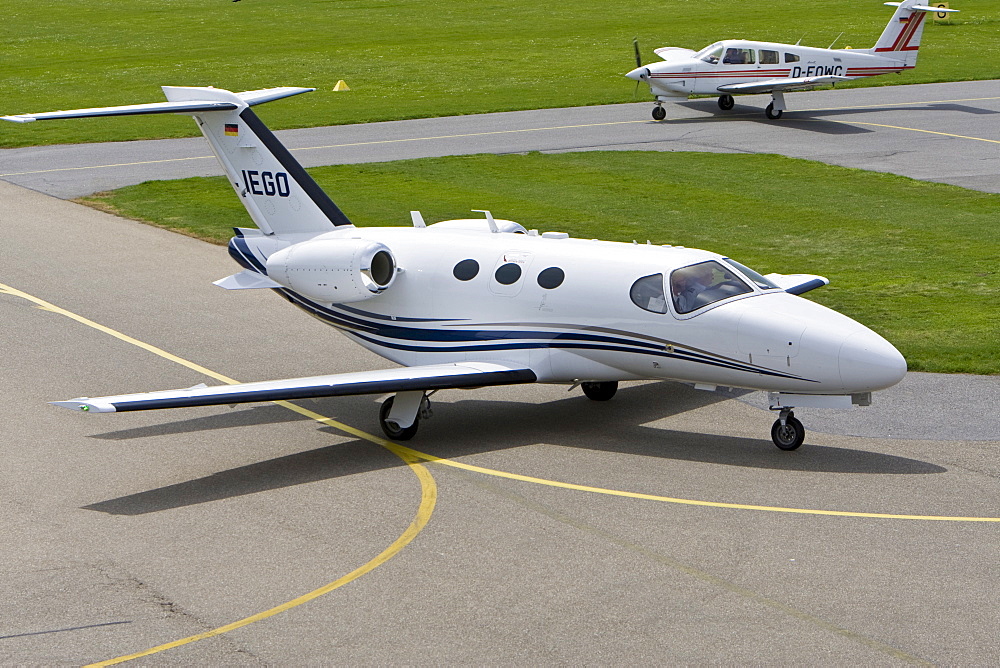 Small, twin-engined business jet taxiing on the runway of Mannheim Airport, Baden-Wuerttemberg, Germany, Europe