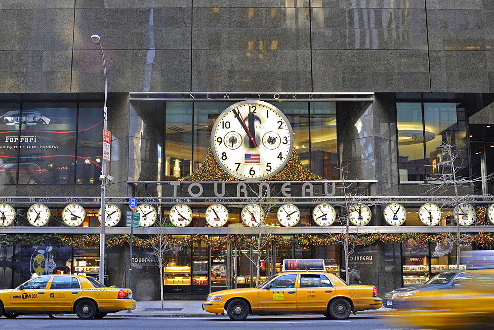 Midtown Manhattan, 5th Avenue. Tourneau clock store with many big clocks, showing the different times in the world, Corner 57th Street, New York, USA